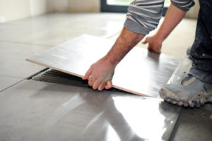 Man laying floor tiles